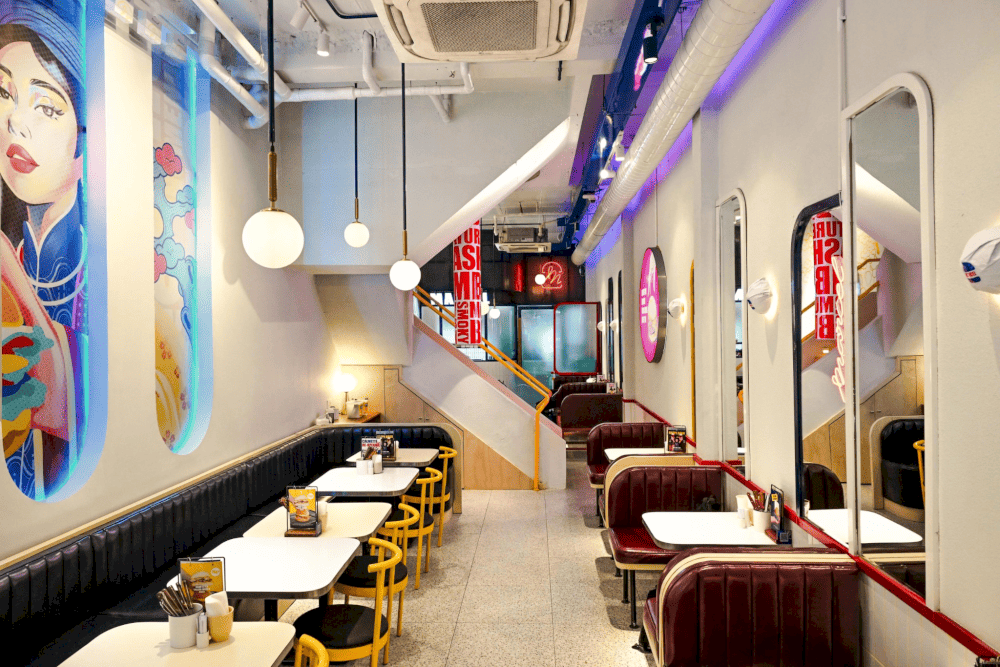 Marcel’s interior channels a modern bistro vibe, with warm wood furnishings and globe pendant lights (Source: Marcel)